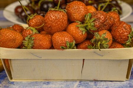 Strawberries in wooden bowl. Fresh nice strawberries on wooden table. Juice strawberryの写真素材