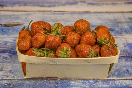 ripe strawberries in a beautiful basket on a wooden background. juicy strawberries.の写真素材