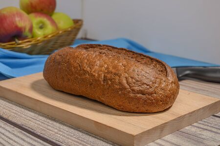 Fresh craft bread on a wooden chopping Boardの写真素材