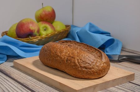 Fresh craft bread on a wooden chopping Boardの写真素材