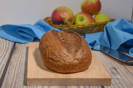 Fresh craft bread on a wooden chopping Boardの写真素材