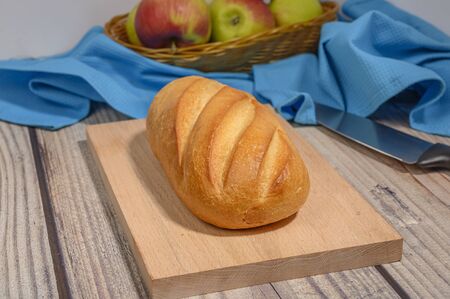 Fresh craft bread on a wooden chopping Boardの写真素材