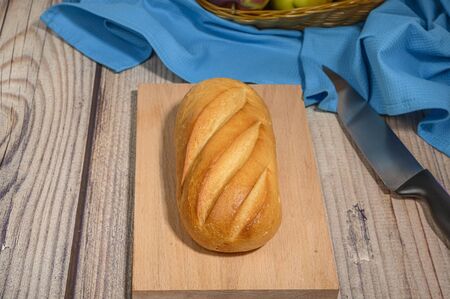 Fresh craft bread on a wooden chopping Boardの写真素材