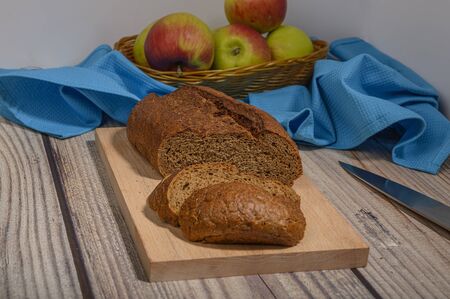 Fresh craft bread on a wooden chopping Boardの写真素材