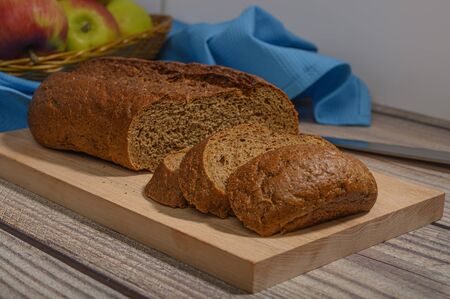 Fresh craft bread on a wooden chopping Boardの写真素材