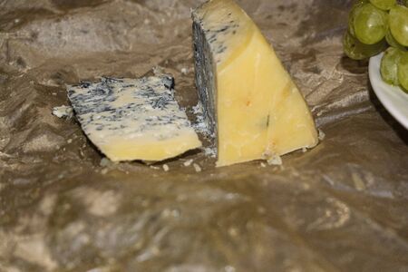 Gorgonzola cheese with blue mold and green grapes. Rustic dinner in vintage style.の写真素材