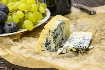 Gorgonzola cheese with blue mold and green grapes. Rustic dinner in vintage style.の写真素材