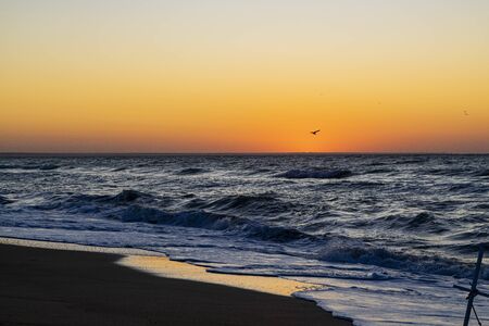 Sunrise over the Black sea, waves on the sandy beachの写真素材