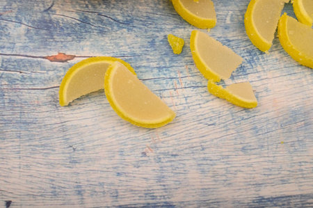 Marmalade lemon slices on wooden background. Sweet dessert. Close upの写真素材