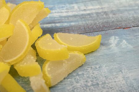 Marmalade lemon slices on wooden background. Sweet dessert. Close upの写真素材