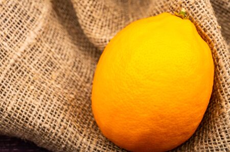 Juicy ripe lemon on a background of textured fabric. Close upの写真素材