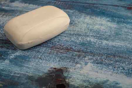 A piece of toilet soap on a wooden background. Close up. Clean hands prevention of COVID-19 infectionの写真素材