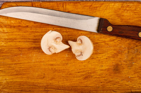 Halves of a cut mushroom on a wooden background. Close up