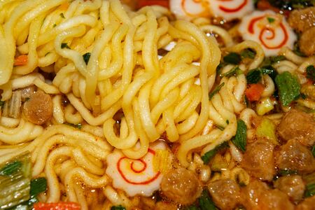 Cooked instant noodles with spices, dried vegetables and freeze-dried meat. Close upの写真素材