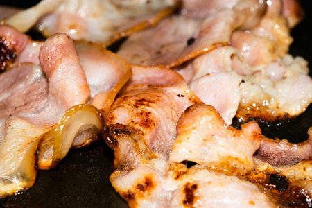 Fried slices of raw bacon. Close upの写真素材