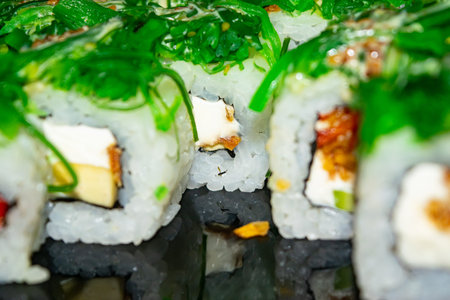 Rolls with fish, cheese and green algae. A traditional Japanese dish. Close upの写真素材