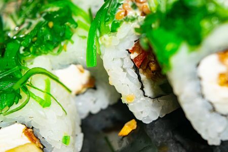 Rolls with fish, cheese and green algae. A traditional Japanese dish. Close upの写真素材