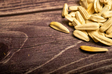 White sunflower seeds fried with sea salt on a wooden background. Close upの写真素材
