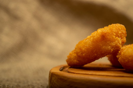 Atlantic prawns fried in batter on a wooden serving Board. Close up