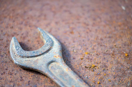 An old spanner on a rusty sheet of metal, close-up, selective focusの写真素材