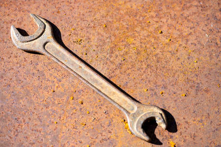 An old spanner on a rusty sheet of metal, close-up, selective focus.の写真素材