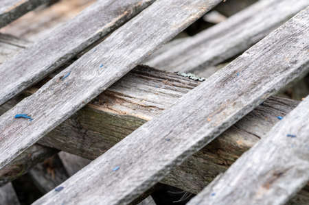 A pile of old boards suitable for the furnace, close-up, selective focusの写真素材