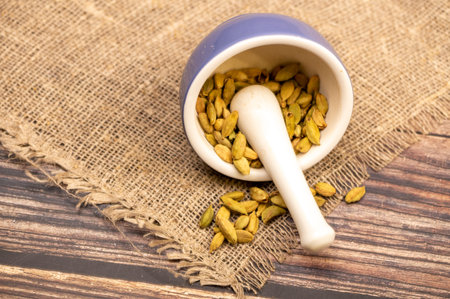 Cardamom in a ceramic mortar and pestle, close-up, selective focus