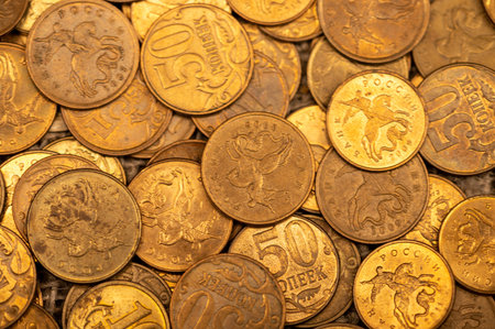 Old coins are scattered on rough sacking. Close up. Background image
