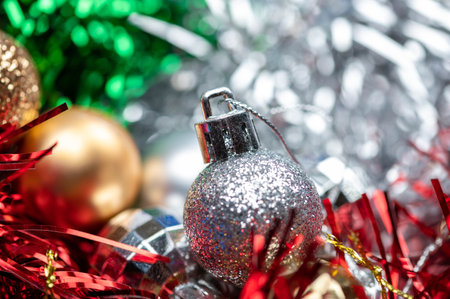 Shiny balloons and colorful tinsel elements of Christmas tree decoration, Close-up, selective focus....