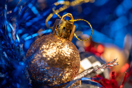 Beautiful glass balls and colored tinsel elements of Christmas tree decoration. New year and Christmas are your favorite holidays. Close-up, selective focusの写真素材