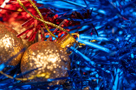 Beautiful glass balls and colored tinsel elements of Christmas tree decoration. New year and Christmas are your favorite holidays. Close-up, selective focusの写真素材