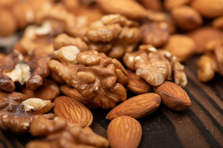 Almonds and walnuts scattered on the table. Close-up, selective focusの写真素材