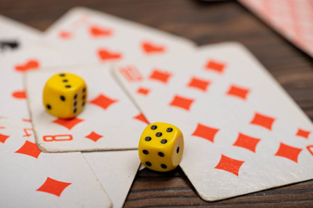 Playing cards and dice on a wooden table. Close-up, selective focus.の写真素材