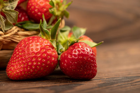 Fresh strawberries on a wooden table. Harvesting. Close-up, selective focus.