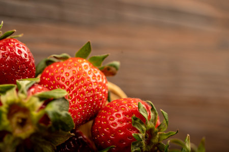 Fresh strawberries on a wooden table. Harvesting. Close-up, selective focus.
