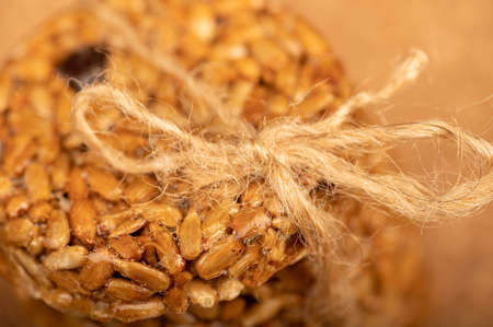 Homemade cookies with sunflower seeds and raisins, tied with string on a wooden table. Close-up Selective focusの写真素材