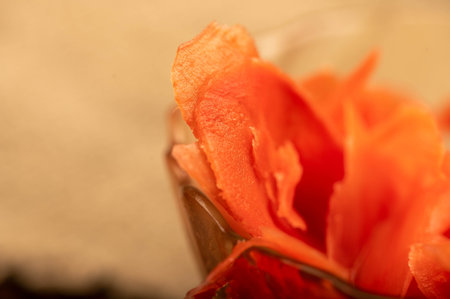 Pickled ginger in a glass dish on a wooden table. Close-up Selective focus