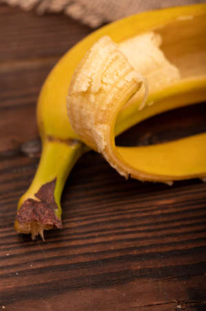 Peeled ripe yellow banana close-up. Selective focus. Autumn harvestの写真素材