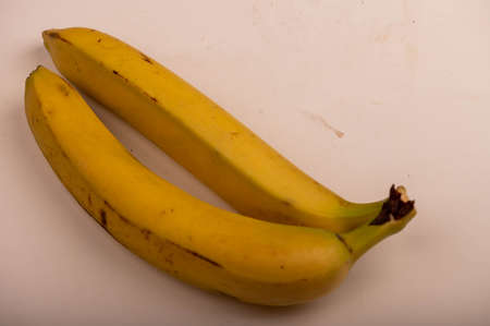 A bunch of ripe yellow bananas in close-up. Selective focus. Autumn harvestの写真素材