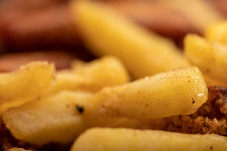 Fried chicken wings and French fries on a plate, close-up, selective focusの写真素材