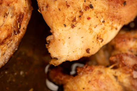 Fried pieces of meat in a frying pan, close-up, selective focusの写真素材