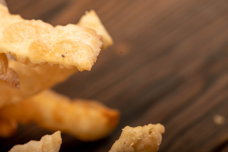Fried breadsticks with salt, close-up, selective focus