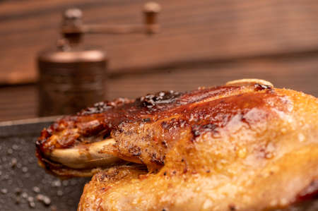 Pieces of roast duck with spices in a frying pan, close-up, selective focusの写真素材