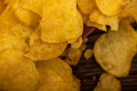 Potato chips scattered on the table, close-up, selective focusの写真素材