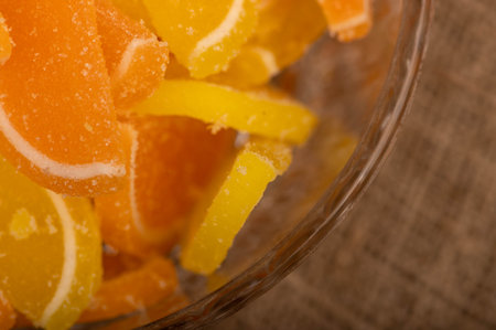 Multi-colored shaped marmalade lemon slices in a glass vase, close-up, selective focusの写真素材