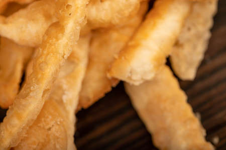 Fried breadsticks with salt, close-up, selective focusの写真素材