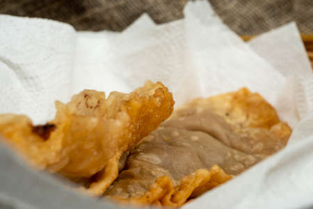 A homemade dish of Uzbek and Tatar cuisine, pasties with meat, suluguni cheese and herbs. Chebureks - fried pie with meat and onions. A traditional dish of Turkish and Mongolian cuisineの写真素材