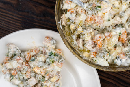 Russian traditional Olivier salad with vegetables and meat. Winter salad for New Year and Christmas....