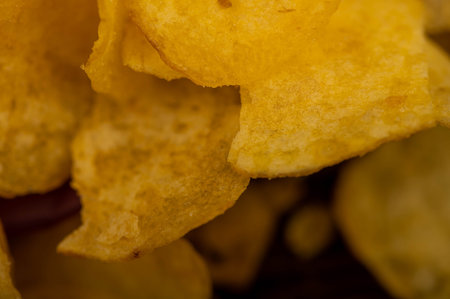 Potato chips scattered on the table, close-up, selective focus