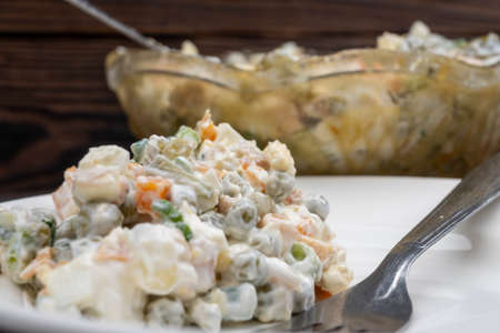 Russian traditional Olivier salad with vegetables and meat. Winter salad for New Year and Christmas. close up, selective focusの写真素材